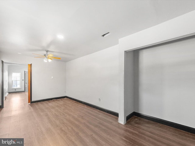 spare room featuring wood-type flooring and ceiling fan