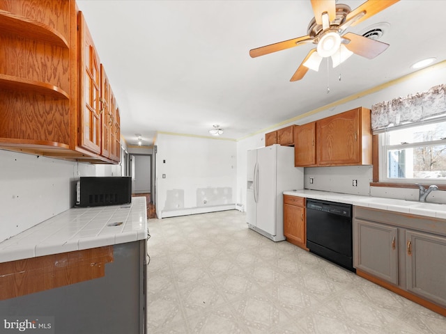 kitchen featuring tile counters, black appliances, ceiling fan, sink, and a baseboard radiator