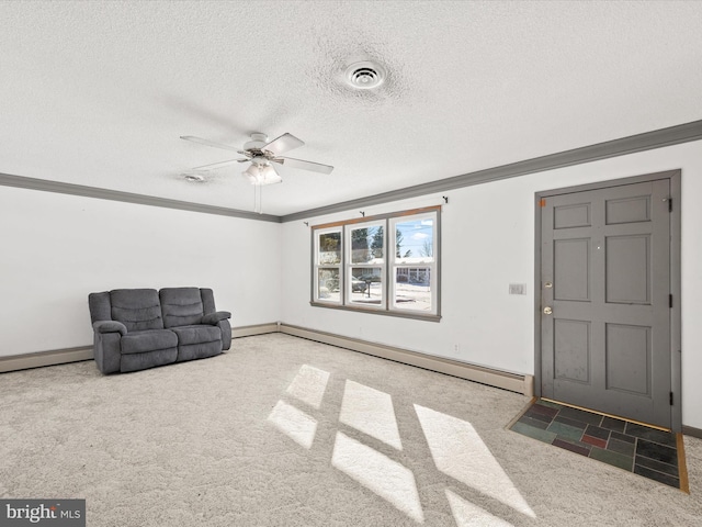 sitting room with baseboard heating, crown molding, ceiling fan, carpet flooring, and a textured ceiling