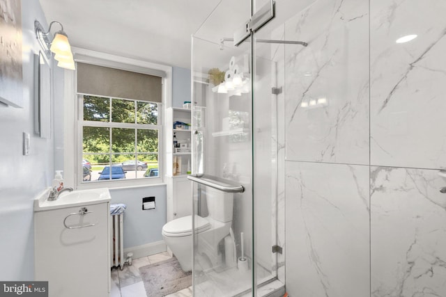 bathroom featuring vanity, radiator heating unit, toilet, and walk in shower