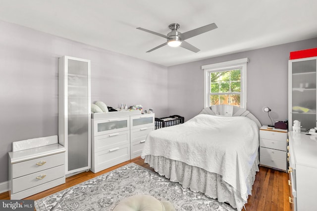 bedroom featuring dark hardwood / wood-style flooring and ceiling fan