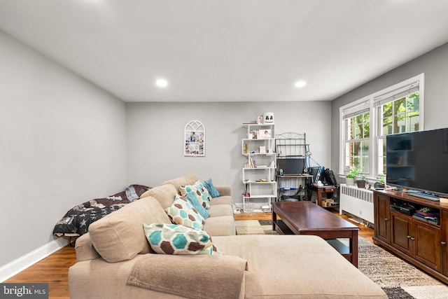 living room featuring radiator and hardwood / wood-style floors