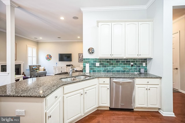 kitchen with white cabinets, dark stone countertops, kitchen peninsula, sink, and stainless steel dishwasher