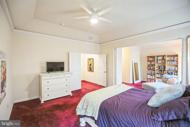 bedroom with vaulted ceiling, a tray ceiling, crown molding, ceiling fan, and dark carpet