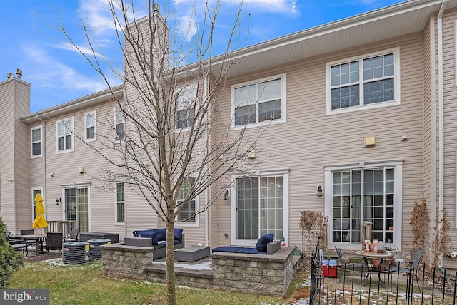 back of house featuring central air condition unit, a patio area, and an outdoor living space