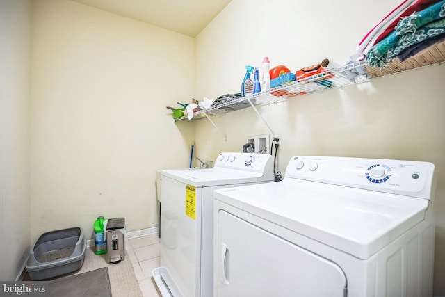 washroom featuring separate washer and dryer and light tile patterned floors