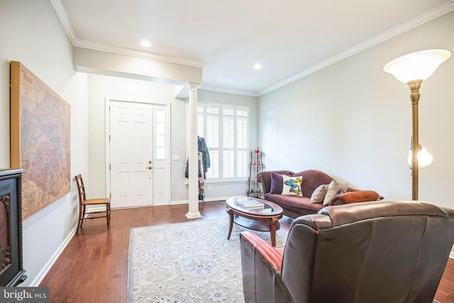 living room with decorative columns, crown molding, and dark wood-type flooring