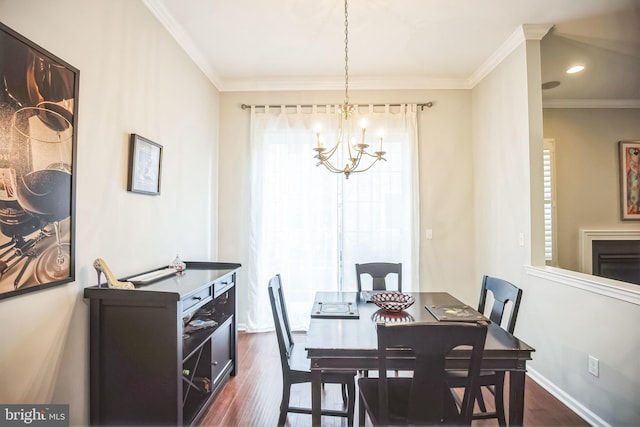 dining area featuring a chandelier, crown molding, and dark hardwood / wood-style floors