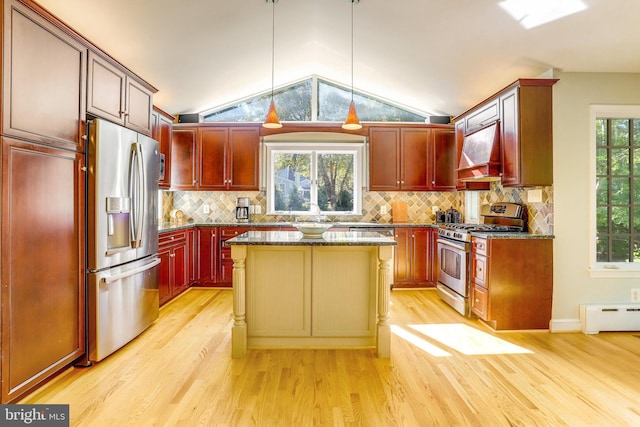 kitchen featuring a kitchen island, dark stone countertops, hanging light fixtures, stainless steel appliances, and custom range hood