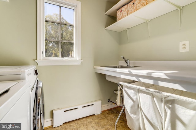 laundry area featuring independent washer and dryer, a baseboard radiator, and sink