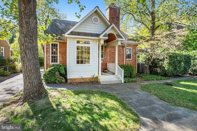 view of front of house featuring a front yard and central air condition unit