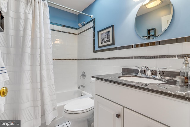 full bathroom featuring shower / bath combo with shower curtain, vanity, toilet, and tile walls