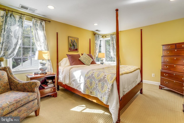 bedroom featuring multiple windows and light colored carpet