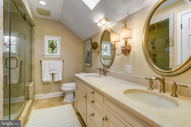 bathroom featuring vanity, lofted ceiling with skylight, toilet, and walk in shower