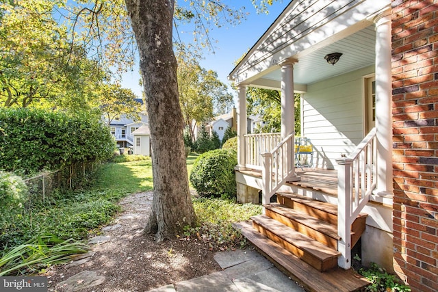 view of yard with covered porch