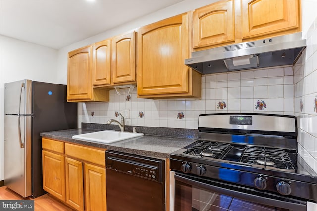 kitchen with backsplash, sink, and black appliances