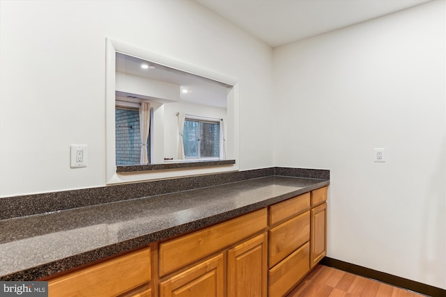 bathroom with vanity and hardwood / wood-style flooring