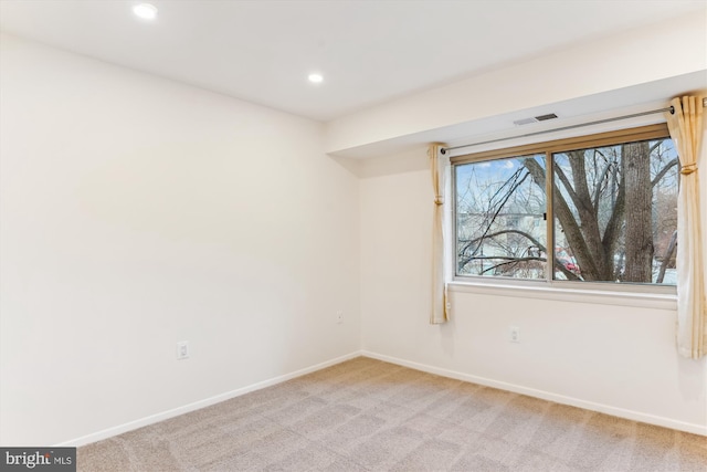 empty room featuring light colored carpet