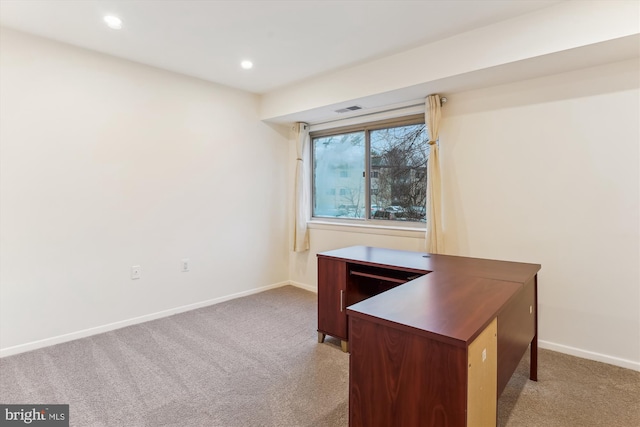 unfurnished office featuring light colored carpet