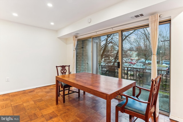 dining room with parquet floors and a healthy amount of sunlight