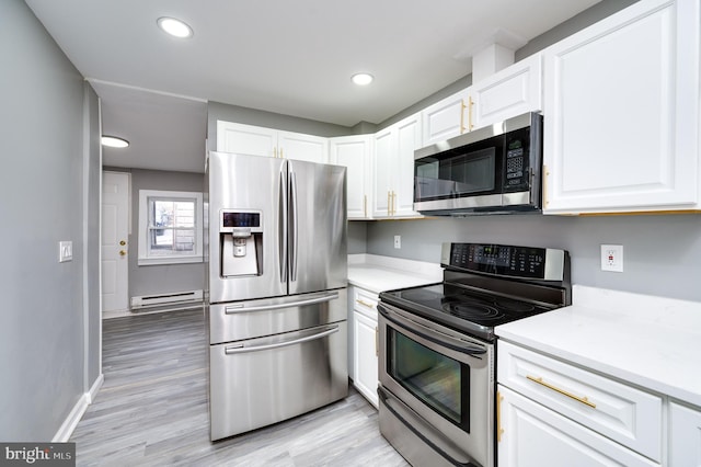 kitchen with appliances with stainless steel finishes, light wood-type flooring, white cabinetry, and baseboard heating