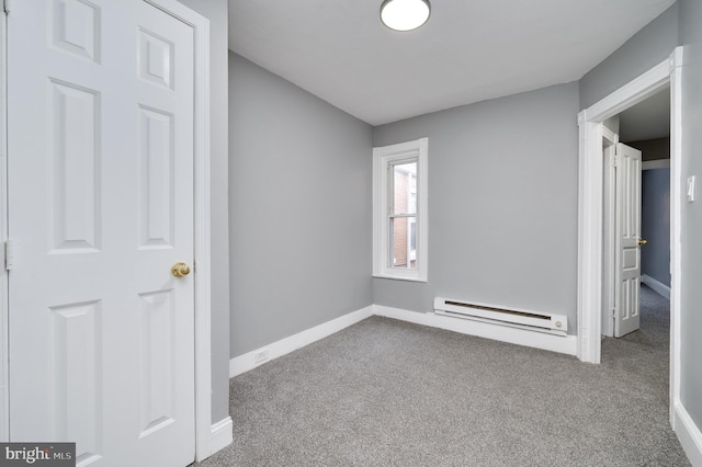 unfurnished bedroom featuring carpet flooring and a baseboard radiator