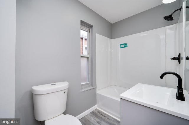 full bathroom featuring vanity, toilet, wood-type flooring, and tub / shower combination