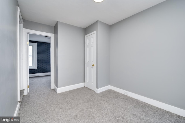 unfurnished room featuring light carpet