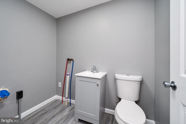 bathroom featuring hardwood / wood-style floors, vanity, and toilet