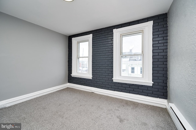 carpeted empty room featuring baseboard heating