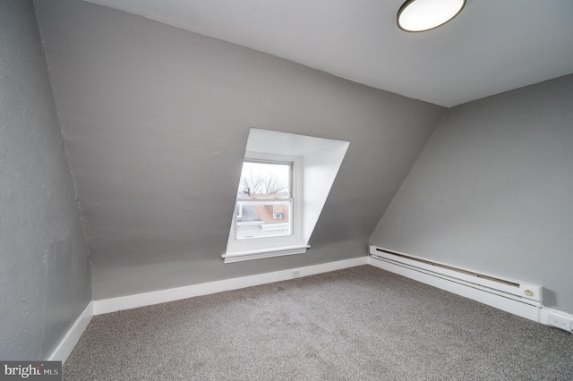 bonus room featuring carpet and a baseboard heating unit