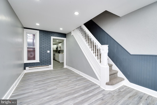 staircase featuring hardwood / wood-style flooring and a baseboard radiator