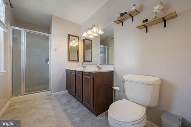 bathroom with toilet, walk in shower, and vanity