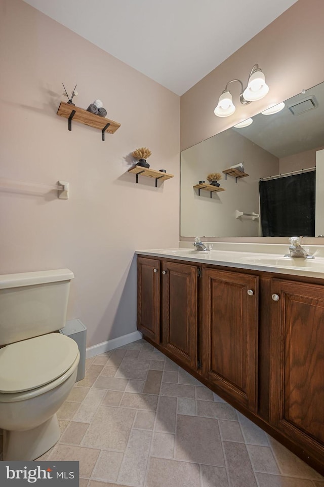 bathroom with vanity and toilet