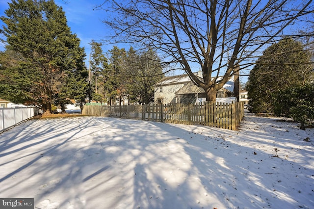 view of yard layered in snow