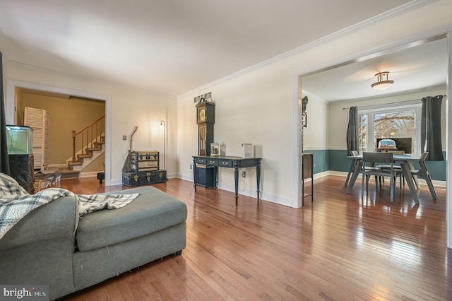 living room with hardwood / wood-style flooring and crown molding