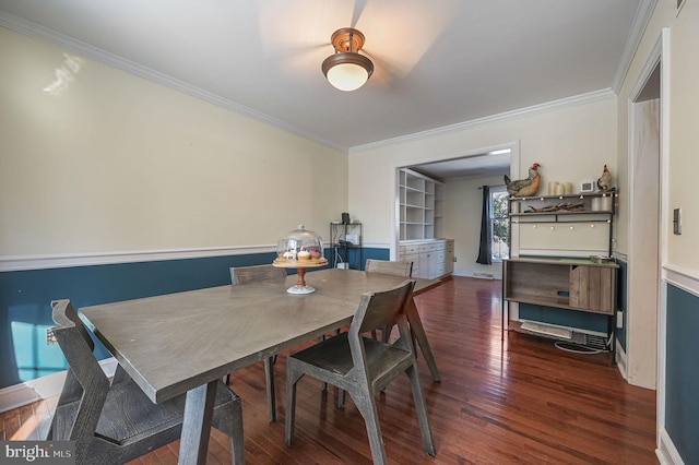 dining area featuring dark wood-type flooring, built in shelves, and ornamental molding