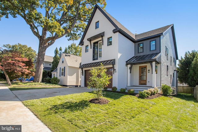 view of front of property with a garage and a front lawn