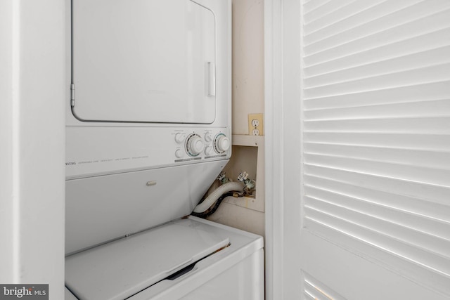 laundry room with stacked washer / drying machine