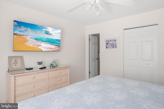 bedroom with ceiling fan and a closet