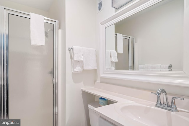 bathroom featuring an enclosed shower and vanity