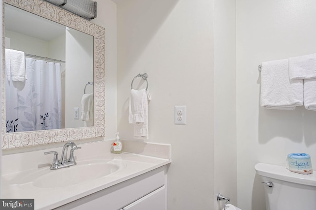 bathroom featuring toilet and vanity