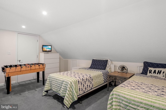 bedroom with lofted ceiling and dark carpet