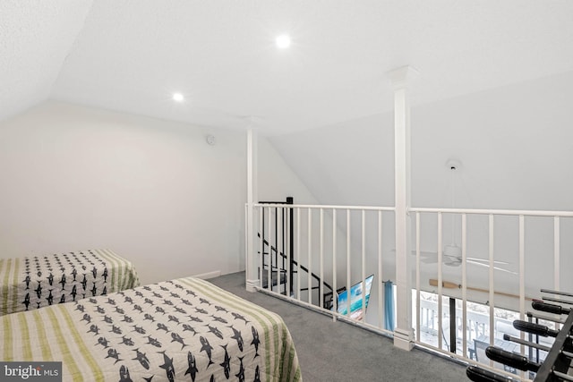 bedroom with lofted ceiling and carpet floors