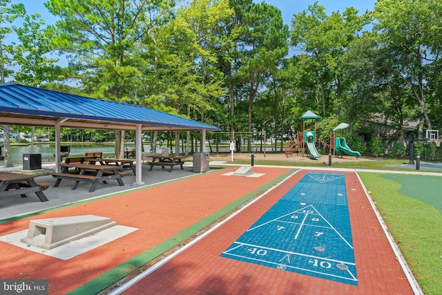 view of community with a playground, a gazebo, and a water view