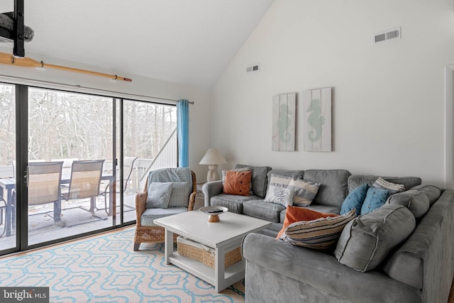 living room with high vaulted ceiling