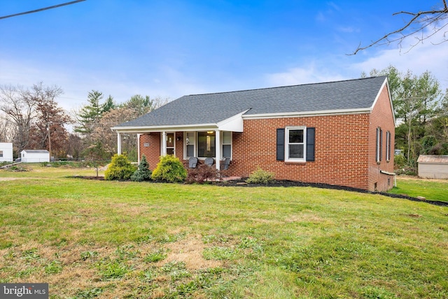 ranch-style home with a front yard and a porch