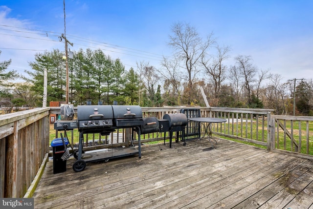 wooden terrace featuring a grill