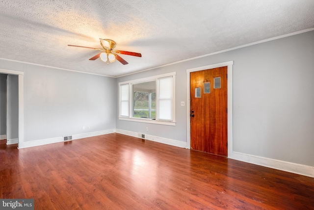 empty room featuring hardwood / wood-style flooring, ceiling fan, crown molding, and a textured ceiling