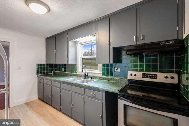 kitchen featuring light wood-type flooring, sink, gray cabinets, and electric stove